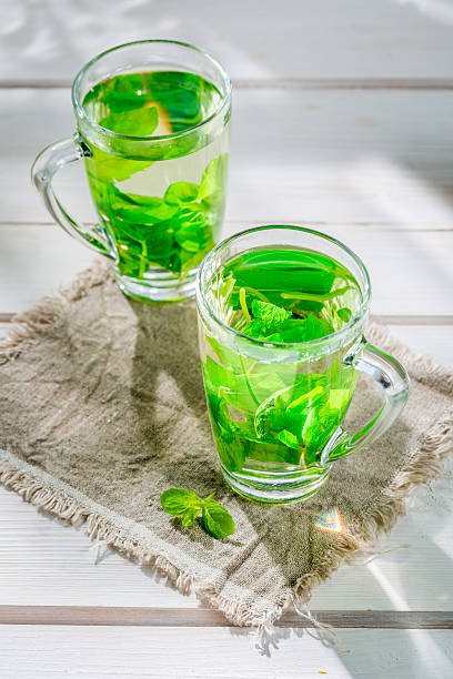 istock Healing mint tea with honey in summer day 513688228