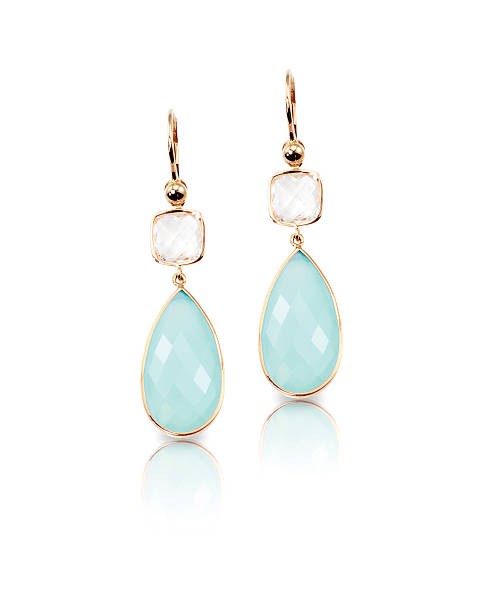 Blue crystal cushion cut quartz and topaz drop earrings Blue crystal cushion cut quartz and topaz drop earrings isolated on white with a reflection gem jewelry gold glamour stock pictures, royalty-free photos & images