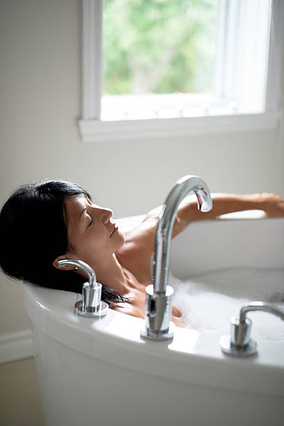 istock mature woman in a bathtub 513688662