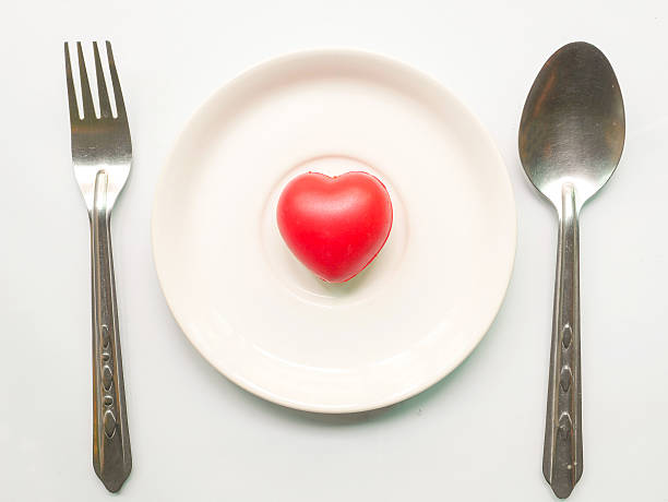 istock Red heart on plate with fork and spoon 513692498