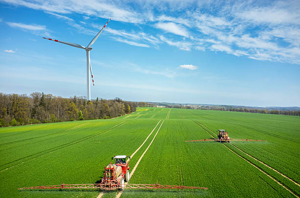 Aerial view of the windmill and the tractors stock photo