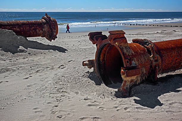 istock rusty pipes along the sea beach 513693802