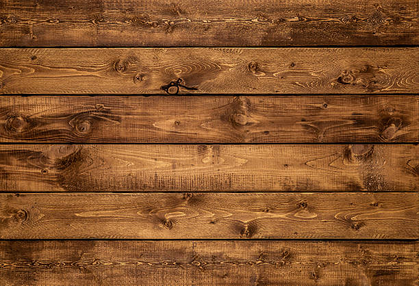 Medium golden brown wood texture background Medium brown wood texture background viewed from above. The wooden planks are stacked horizontally and have a worn look. This surface would be great as design element for a wall, floor, table etc. boarded up photos stock pictures, royalty-free photos & images