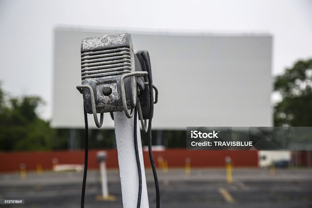 DRIVE IN MOVIE THEATRE + VINTAGE SPEAKER An vacant drive in movie theatre and its vintage speaker. Drive-in Movie Stock Photo