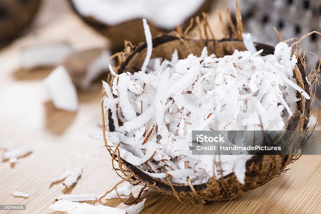 Fresh Grated Coconut Fresh Grated Coconut (detailed close-up shot) on wooden background Close-up Stock Photo