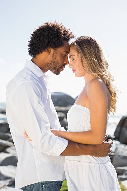 istock Gorgeous couple embracing by the coast 513705233