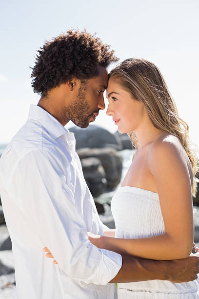 istock Gorgeous couple embracing by the coast 513705235