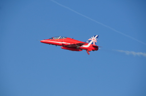 Jersey, U.K.- September 11, 2014: A pilot with the British  Red Arrow display team taking part in the Jersey International Airshow 2014 over St.Aubin's Bay.