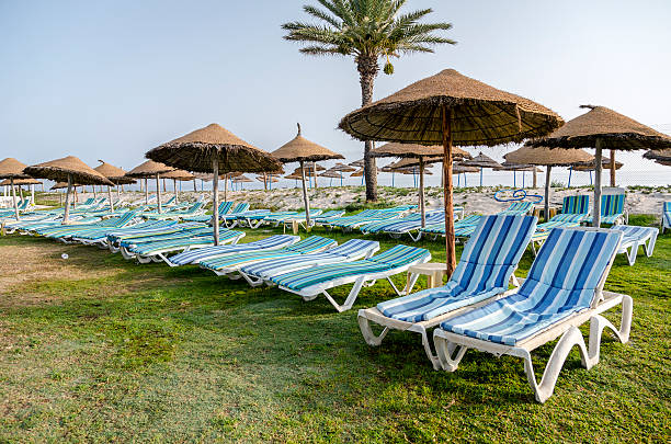 istock Sun umbrella on an empty beach and sea water horizon. 513706475