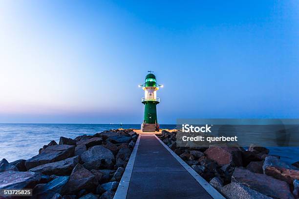 Lighthouse In Sunset Stock Photo - Download Image Now - Lighthouse, Warnemünde, Night
