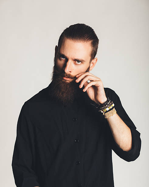 istock Young handsome man in black shirt on white background 513725945