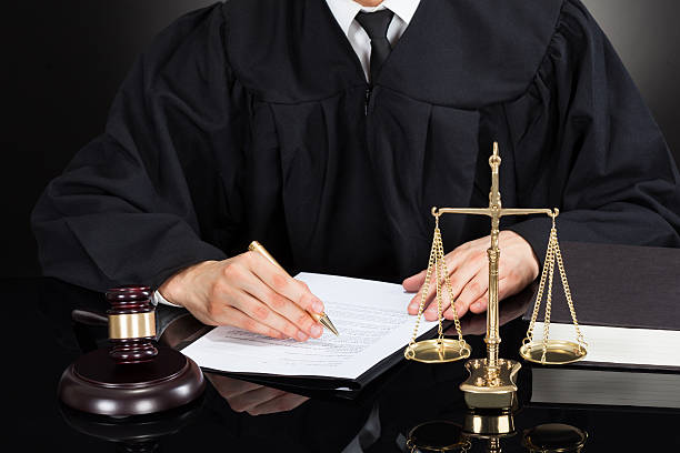 istock Judge Writing On Paper At Desk 513726831