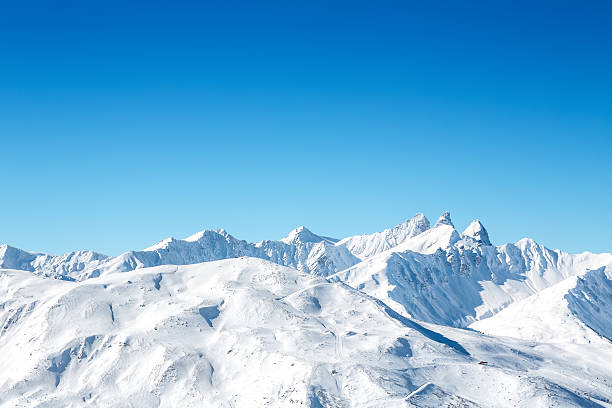 Ski Slopes In French Mountains Mountains covered with snow on a sunny day. Copy space. savoie photos stock pictures, royalty-free photos & images