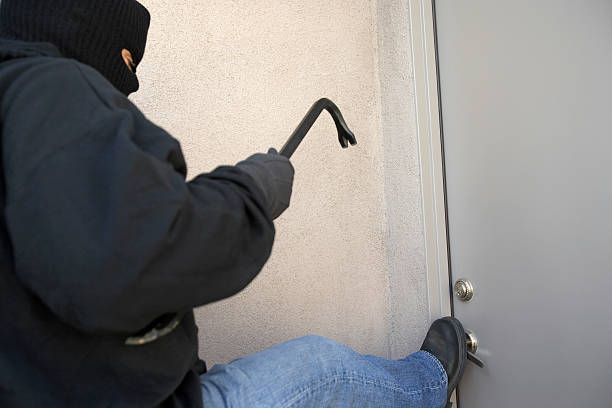 istock Burglar breaking into home 513729317