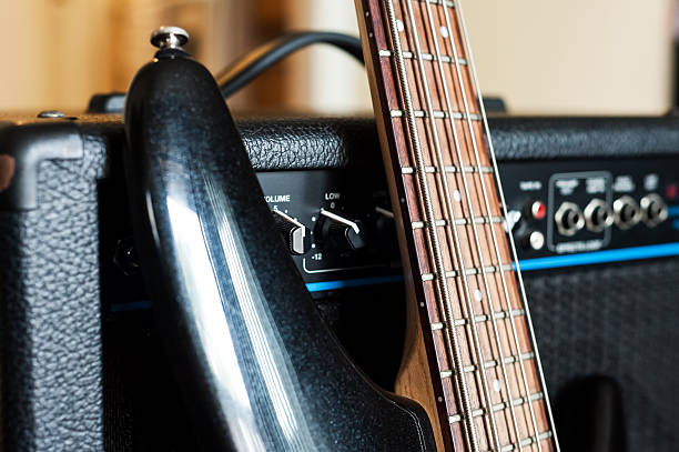 istock Five string electric bass guitar fingerboard and combo close up 513729385