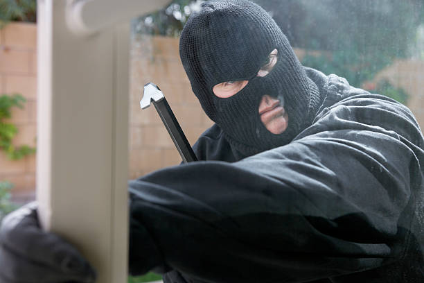 istock Burglar breaking into home 513730551