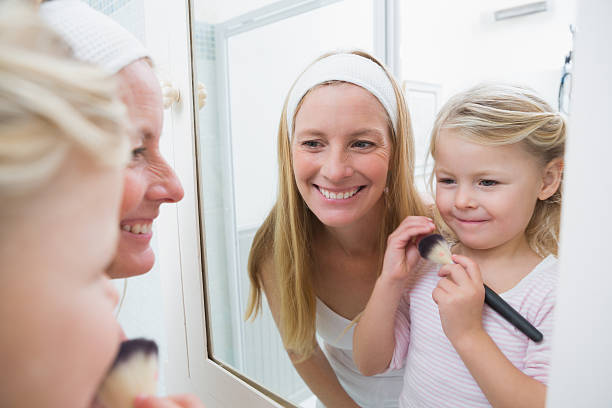 istock Happy mother and daughter playing with make up 513731987