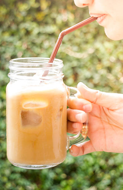 istock Happy woman drinking cold coffee with vintage filter effect 513733316