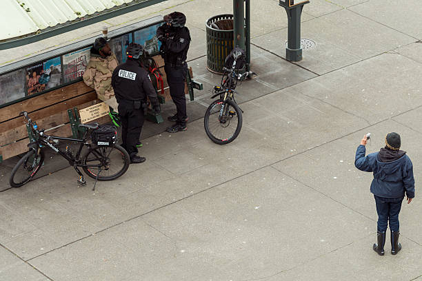 Seattle Crime Seattle, USA - March 2, 2016: Seattle Police arresting a man mid day in Pike Place Market for allegedly selling drugs after police witness an exchange, While a woman video tapes the arrest. german social democratic party photos stock pictures, royalty-free photos & images