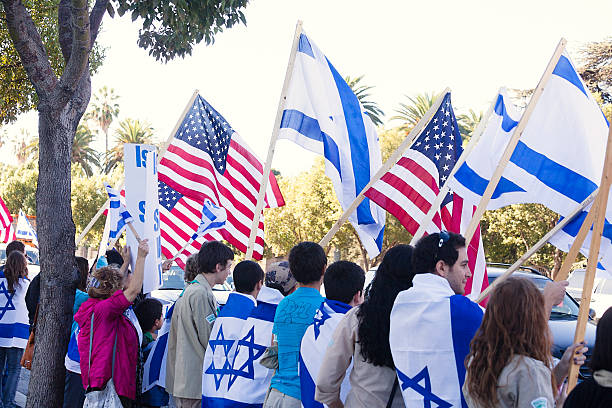 New York, New York - May 18, 2025: Participants Holding Israeli Flag Enthusiastically Israel Day Parade NYC 2025