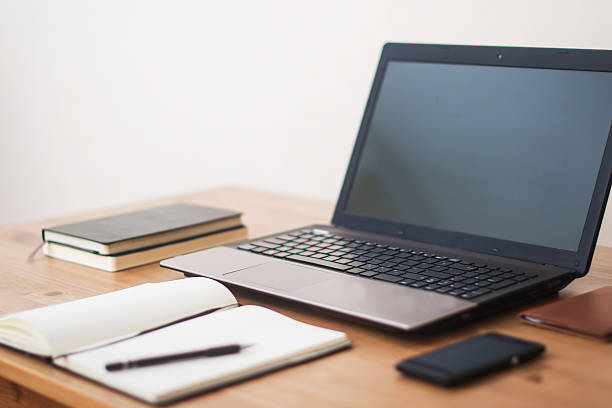 istock Office workplace with laptop, smart phone and notebook on table 513736960