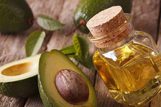 istock fresh avocado oil in a glass bottle close-up. Horizontal 513737036
