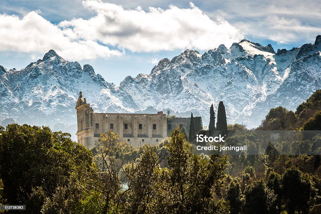 San Francesco convent and mountains at Castifao in Corsica Ruin of San Francesco convent in the village of Castifao in Corsica set against snow covered mountains Corsica Stock Photo