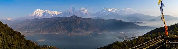 The typical spring morning landscapes of Pokhara, Nepal with its reflective lake and snow capped Himalayas.