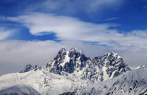istock Mounts Ushba and Chatyn and blue sky with clouds 513741054