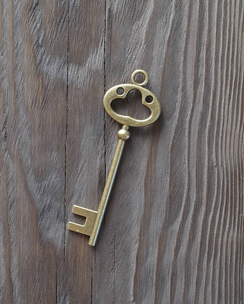 istock Vintage Key on Wooden Surface 513742540