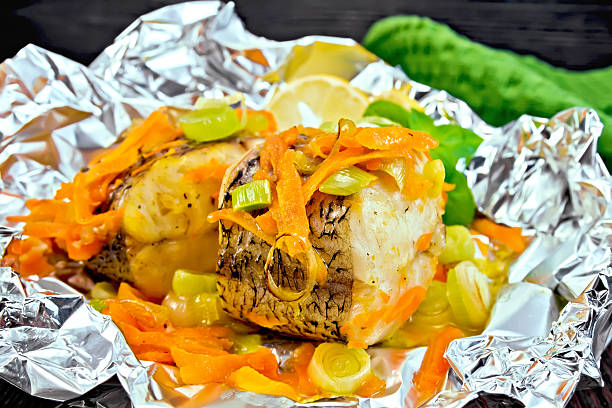 istock Pike with carrots and onions in foil on board 513743858