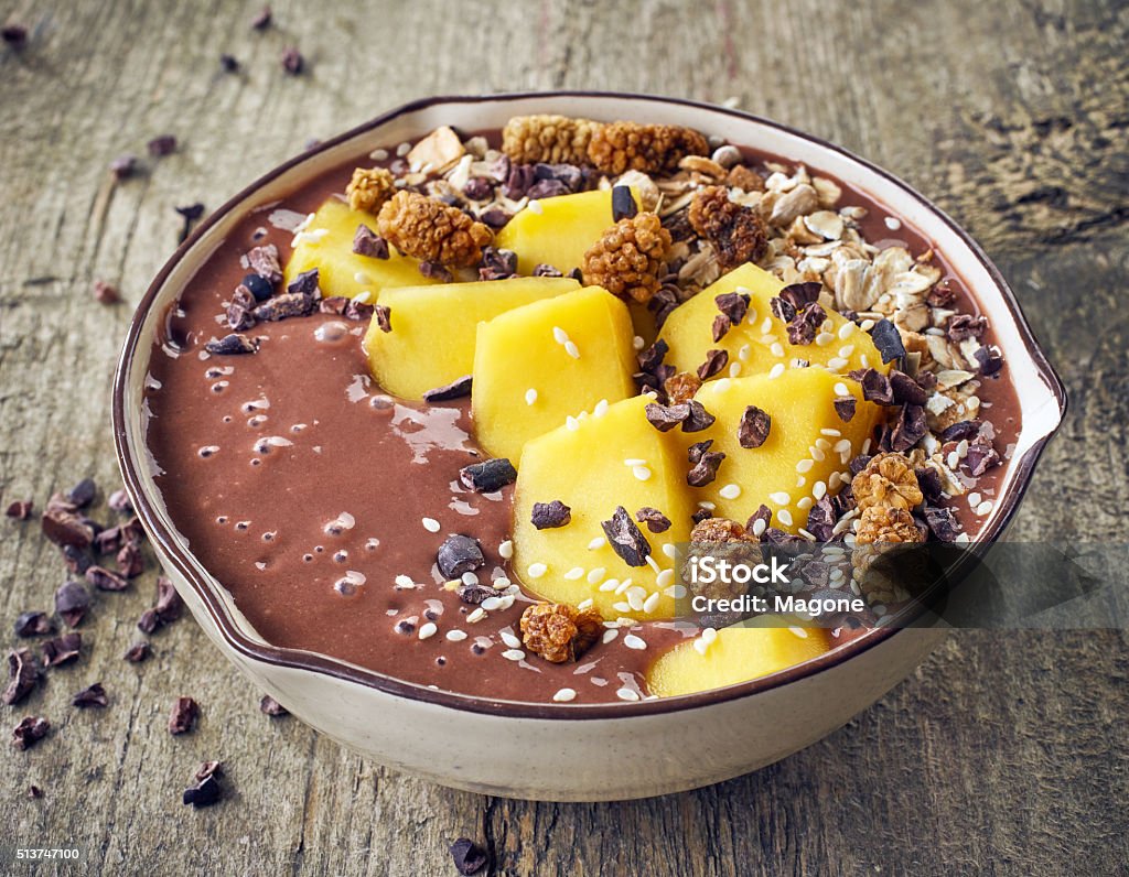 breakfast smoothie bowl breakfast banana and chocolate smoothie bowl topped with mango and superfoods Antioxidant Stock Photo