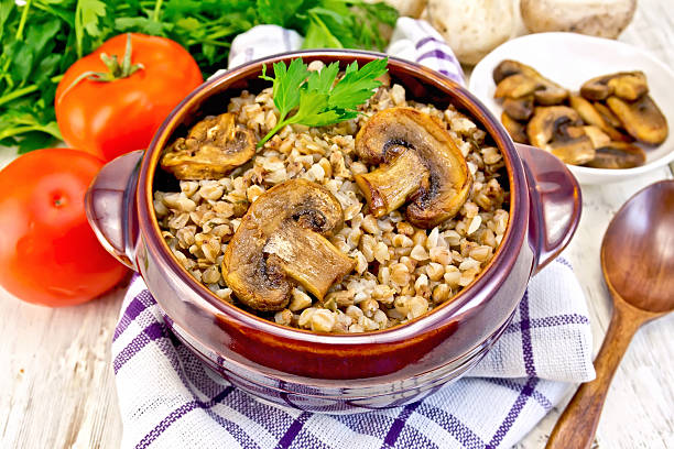 istock Buckwheat with champignons in clay bowl on napkin 513747312