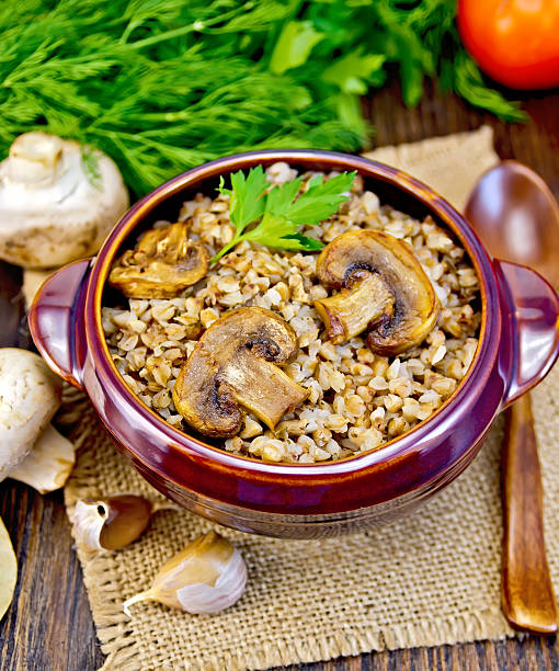 istock Buckwheat with champignons in clay bowl on sacking 513747458