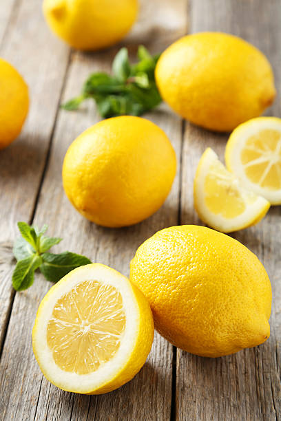 istock Lemons on grey wooden background 513747588