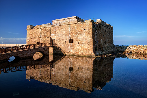 The castle of Paphos in the morning with reflection on the water, Cyprus