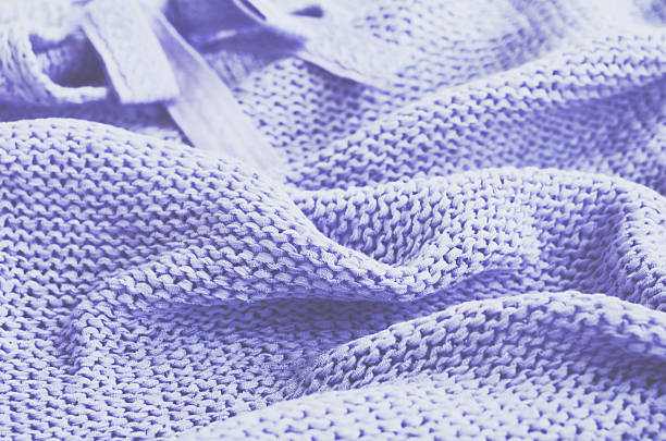 istock Knitted sweater of lavender color, selective focus 513750360
