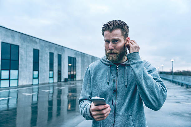 istock Male runner gets ready for run and listens to music 513751496