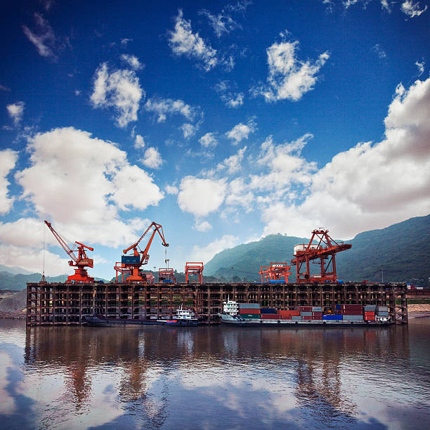 Shipping in Chongqing, China Shipping on the Yangtze River in Chongqing, China. level luffing crane stock pictures, royalty-free photos & images