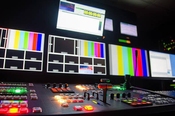 Broadcast television switcher Broadcast television switcher in progress. television studio photos stock pictures, royalty-free photos & images