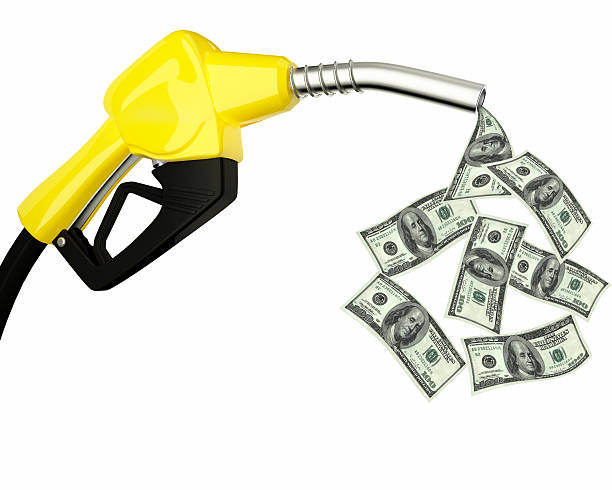 istock fuel nozzle with dollars flying around 513752008