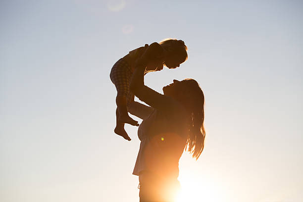istock mother and little daughter play at sunset 513752304