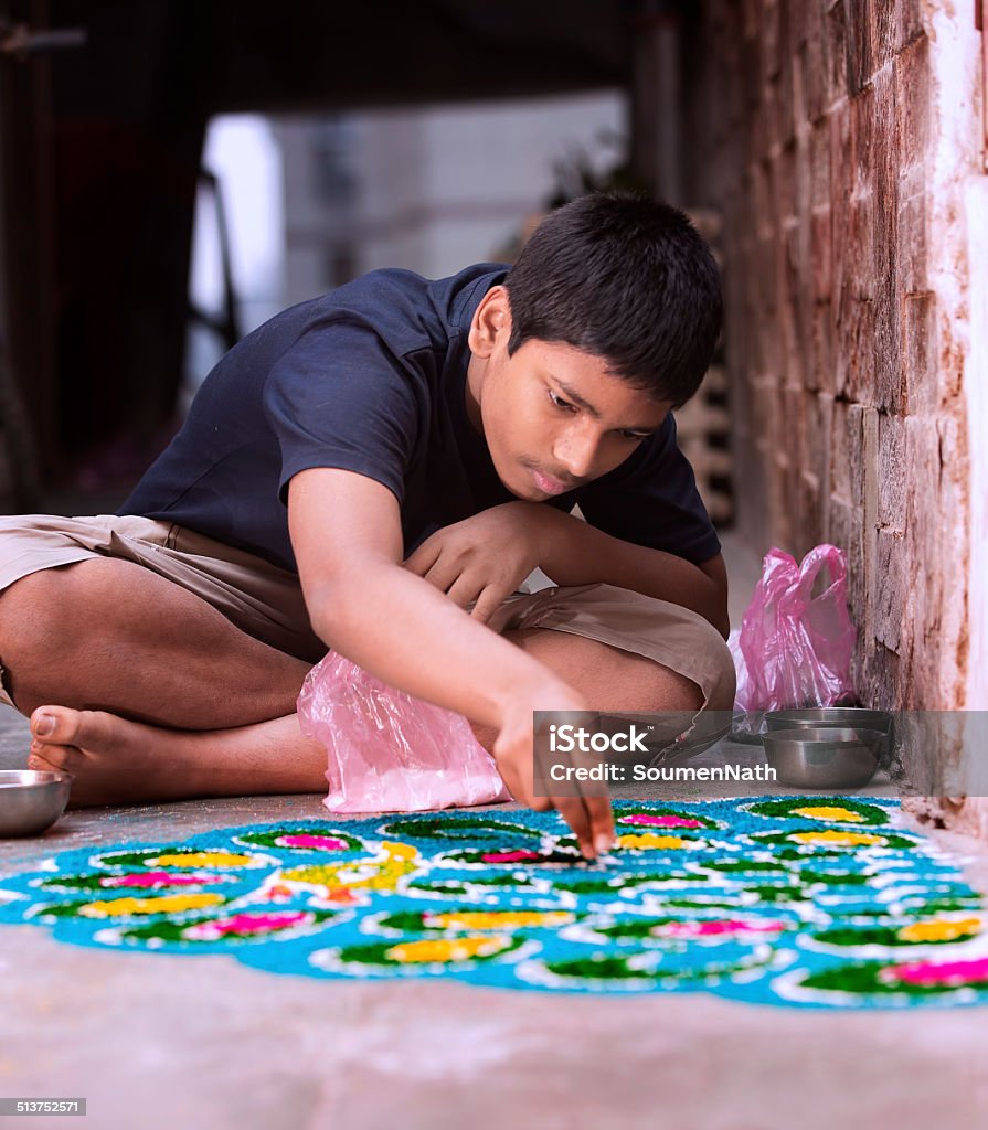 Teenage boy making Rangoli for Diwali Teenage boy making Rangoli for Diwali celebration in India. Rangoli Stock Photo