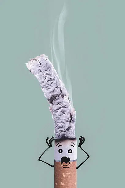 Photo of Burning cigarette and funny character
