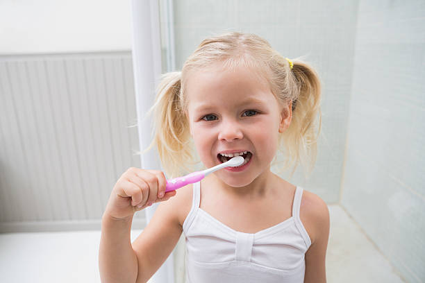 istock Cute girl brushing her teeth 513753215