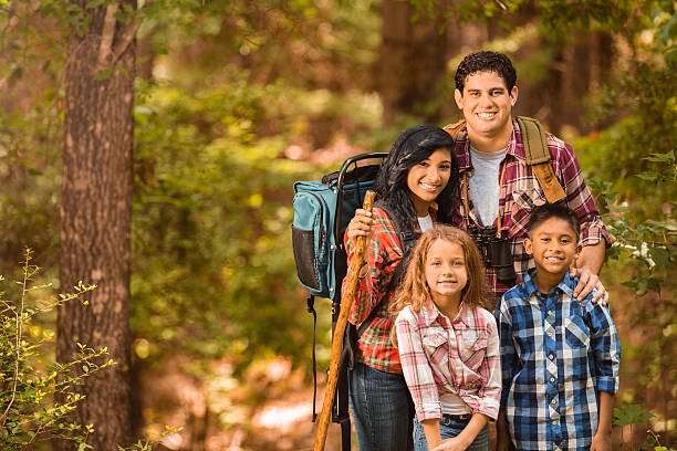 istock Multi-ethnic family hiking, backpacking outdoors in national park area. 513753589