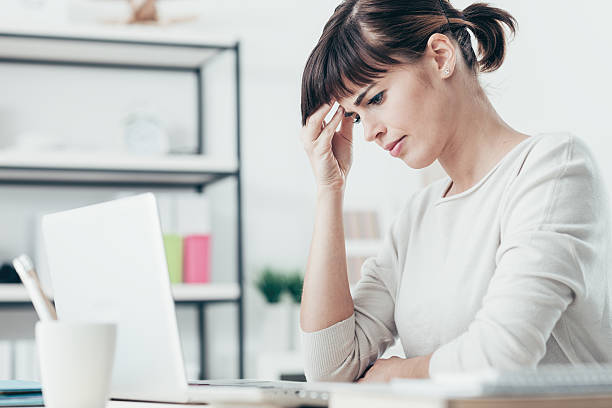 istock Woman with headache in the office 513753682