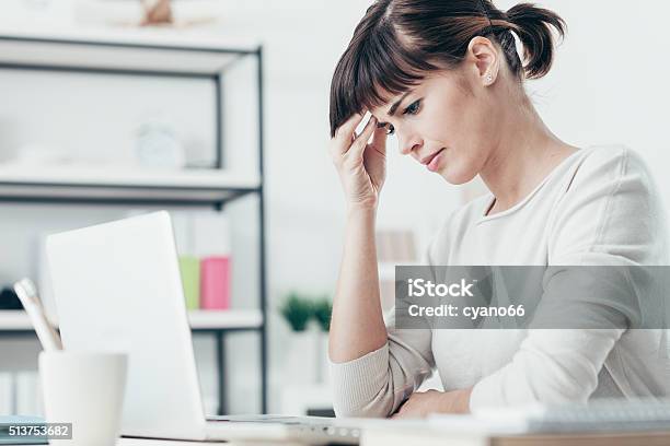 Woman With Headache In The Office Stock Photo - Download Image Now - Adult, Business, Business Finance and Industry