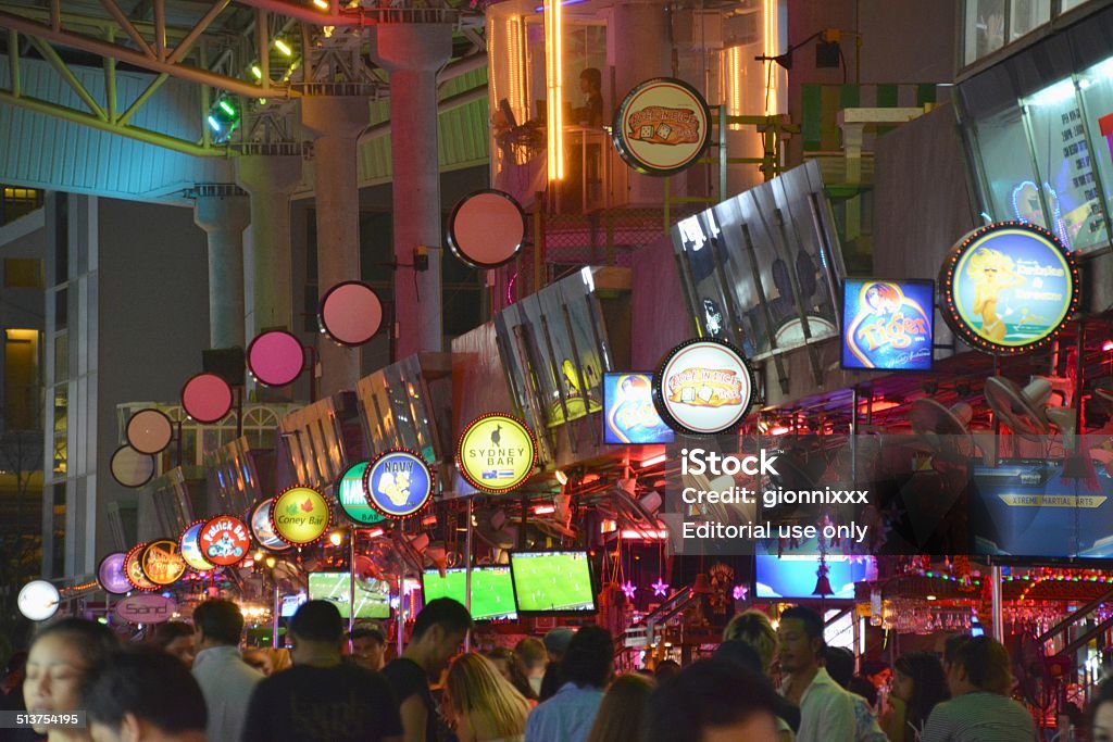 Soi Dragon bars on Bangla Road, Patong beach Patong, Thailand - January 20, 2014: Crowd of tourists walking along Dragon alley, a busy avenue full of bars and neon signs at Bangla road, the main nightlife spot in Patong Beach. Adult Stock Photo