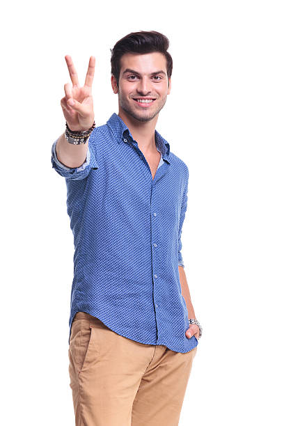 istock young man making the victory peace sign 513754351